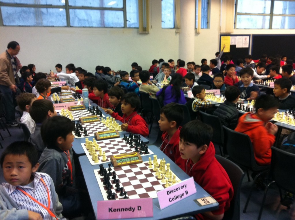 Team B and C sitting in a long row. Team B, foreground (front to back): Jonathan, Maxwell, Aryan and Joaquin