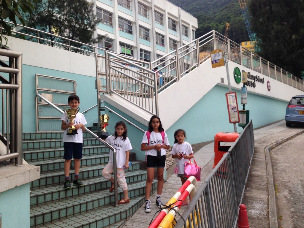 Miguel Angel, Meijing, Samira and Saga leaving Bradbury School. Another trophy still to be received for Discovery College by courtesy of Miguel Angel, Mei Jing and Saga!
